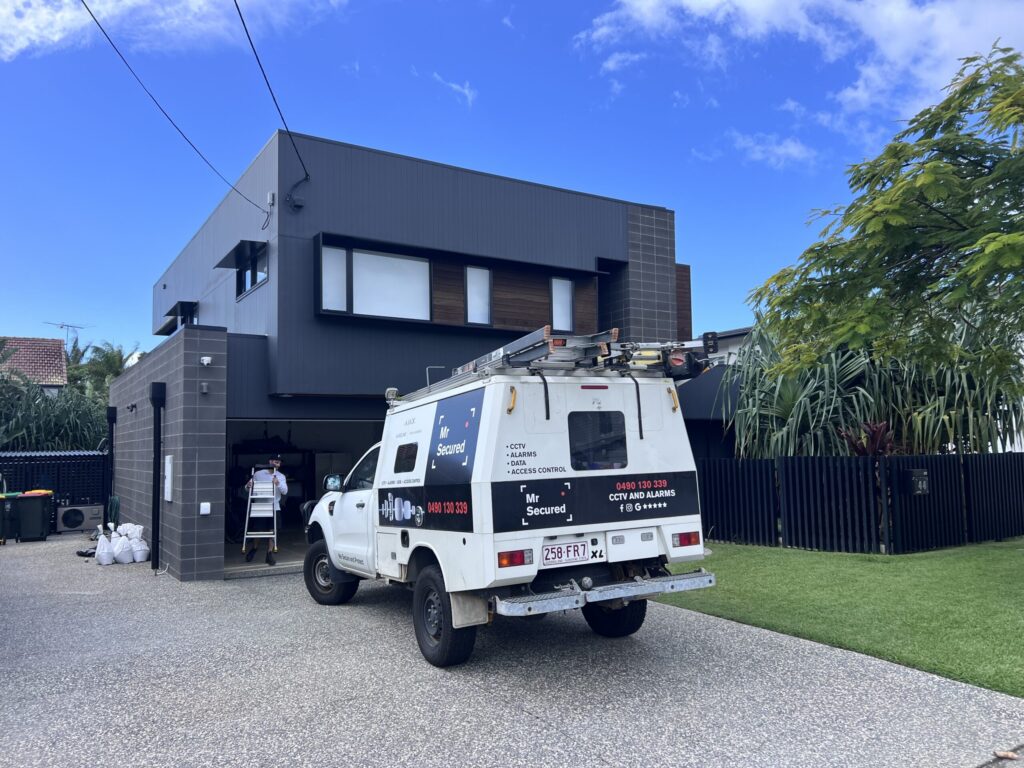 Mr Secured van in the driveway of a modern family home